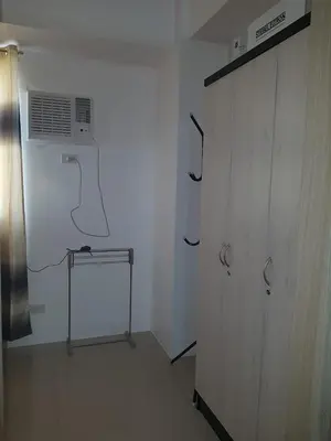 a room with a white wall with a air conditioner at 1 Bedroom Apartment @SMDC Shore Residences, Mall of Asia in Manila
