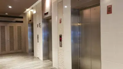 a hallway with two elevators in a building at 1 Bedroom Apartment @SMDC Shore Residences, Mall of Asia in Manila