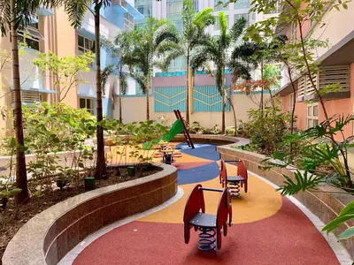 a garden with chairs and a playground in a building at 101 Newport City Chillax C2 Manila Airport Pasay in Manila