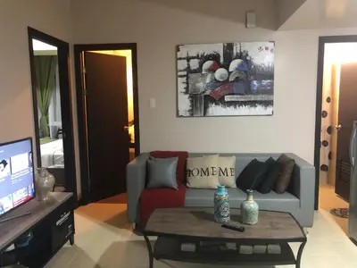 a living room with a couch and a coffee table at SAN LORENZO PLACE 2BR 29-E by LARICO in Manila