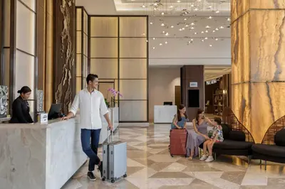 a man walking through a lobby with a suitcase at Sheraton Manila Hotel at Newport World Resorts in Manila