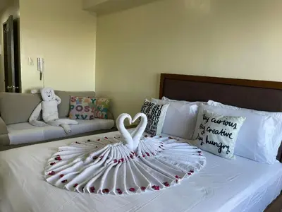 a swan decoration on a bed in a bedroom at Green Residences Stays by PBYY in Manila