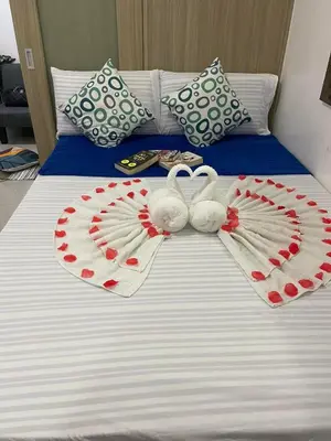 two swans adorned with hearts on a bed at Shore Residences, Mall Of Asia Complex Stayction by PBYY in Manila