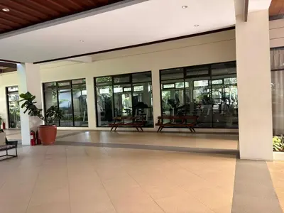 a lobby of a building with large glass windows at Cozy Staycation at Eastbay Residences in Manila