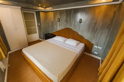 a bedroom with a large bed in a room at CONNECTOR Hostel in Manila