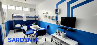 a room with blue and white walls and a table and chairs at ROCCA Del GARDA Residences in Binangonan