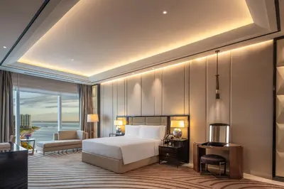 a hotel room with a bed and a balcony at Solaire Resort Entertainment City in Manila