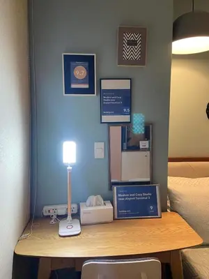 a desk with a lamp on top of a room at Modern and Cozy Studio near Airport Terminal 3 in Manila