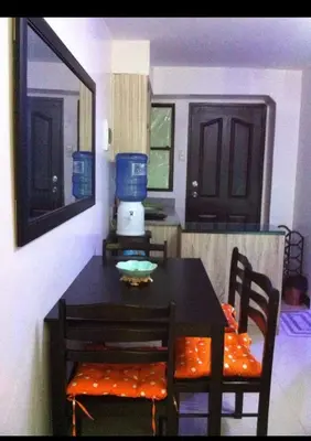 a dining room table with two chairs and a blue blender at Estien’s Cozy Condotel to Stay in Imus