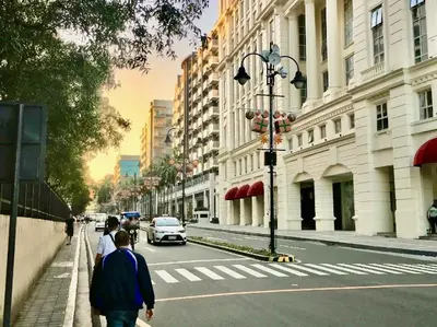 a couple of people walking down a city street at Studio Room Walking Airport, In City Of Newport City in Manila