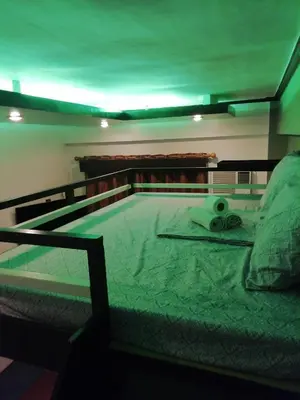 a bed with a pair of scissors on it at NAIA Airport Fasanvej Studio condo NetflixTv 4pax in Manila