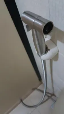 a toilet paper dispenser in a bathroom at Crossroads Hostel Manila in Manila
