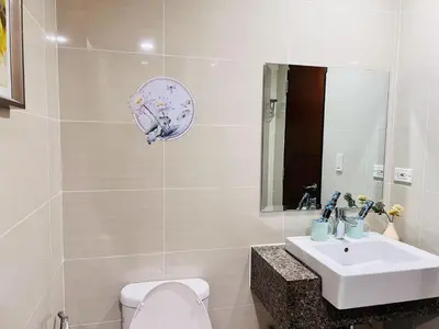 a bathroom with a sink and a toilet and a mirror at ONE UPTOWN \uff08BGC\uff09 in Manila