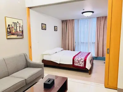 a hotel room with a bed and a couch at ONE UPTOWN \uff08BGC\uff09 in Manila