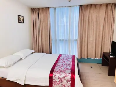 a bedroom with a bed and a large window at ONE UPTOWN \uff08BGC\uff09 in Manila