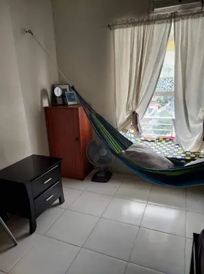a hammock in a room with a window at Cozy Studio @ One Capitol Condo 2nd St. Kapitolyo in Manila