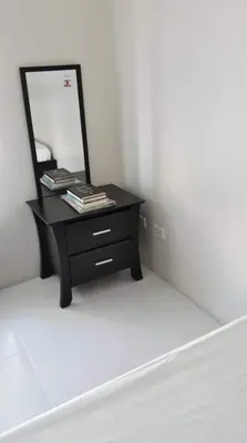 a black dresser with a mirror on top of it at Cozy Studio @ One Capitol Condo 2nd St. Kapitolyo in Manila