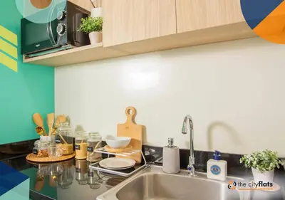 a kitchen with a sink and a counter top at The City Flats Amorsolo in Manila