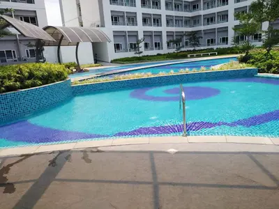 a large swimming pool in front of a building at SMDC GRACE RESIDENCIES in Manila