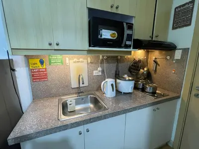 a kitchen counter with a sink and a microwave at SMDC GRACE RESIDENCIES in Manila