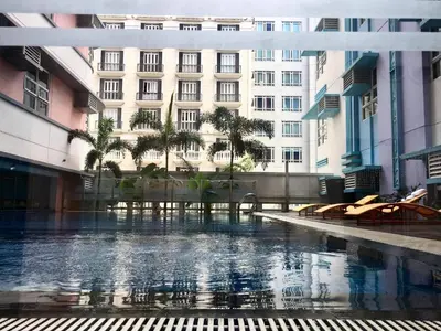 a building with a pool of water in front of a building at Condo 101 Newport in Manila