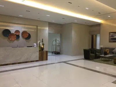 a lobby with a reception desk in a building at Condo 101 Newport in Manila