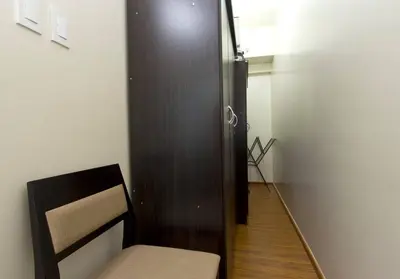 a room with a wooden door and a chair at The Beacon 1BR for 4, T2, WIFI 300Mbps in Manila