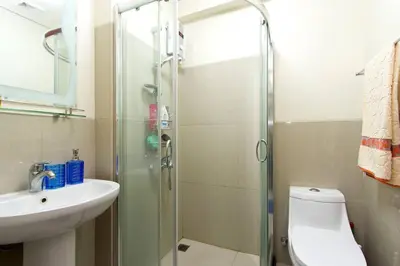 a bathroom with a shower and a toilet and a sink at The Beacon 1BR for 4, T2, WIFI 300Mbps in Manila
