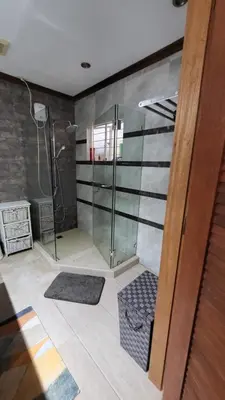 a bathroom with a shower with a glass door at Casa Meyer's BF Homes International House for rent with pool and Jacuzzi in Manila