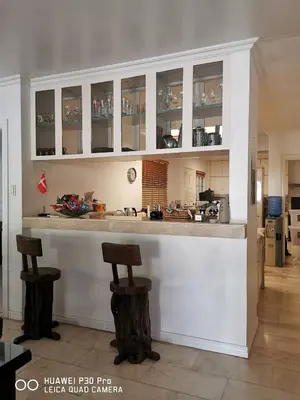 a kitchen with a bar with two stools in it at Casa Meyer's BF Homes International House for rent with pool and Jacuzzi in Manila