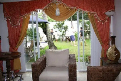 a living room with a chair and a large window at Casa Meyer's BF Homes International House for rent with pool and Jacuzzi in Manila