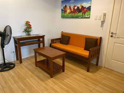 a living room with a couch and a table at AZURE C4 BEACHPOOL balcony wifi MULTIPLE UNITS in Manila