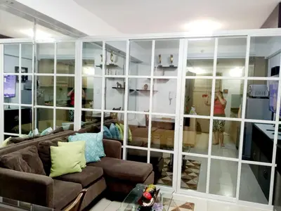 a living room with a large wall of glass at Condominium Shore 1 Mall of Asia in Manila