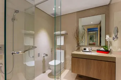 a bathroom with a shower and a toilet and a sink at Summit Hotel Greenhills in Manila