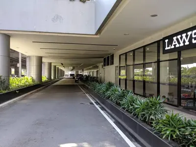 an empty hallway of a building with plants at Studio Condo NAIA Airport Terminal 3 Newport City Casino in Manila