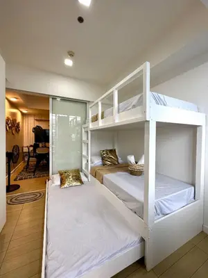 two bunk beds in a room with a piano at Azure Urban Resort Residences, Condo, Manila Airport, Wave-Pool, Tropical Vibe in Manila