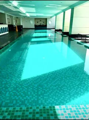 a swimming pool with blue lighting in a building at 1BR Near Beach, Airport & In City of Manila Bay in Manila