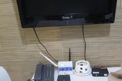 a table with a television and a remote control at CHATEAU ELYSEE a3 near airport Wifi Kitchen in Manila