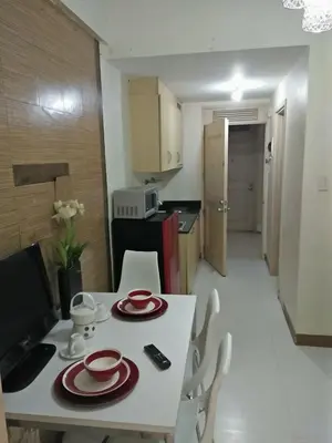 a white table with red plates on it in a kitchen at CHATEAU ELYSEE a3 near airport Wifi Kitchen in Manila