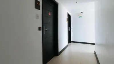 a corridor with two black doors in a room at RedDoorz Plus at MM Hotel Las Pinas former RedDoorz Plus Near Bamboo Organ in Manila