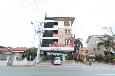 a car parked in front of a building at RedDoorz Plus at MM Hotel Las Pinas former RedDoorz Plus Near Bamboo Organ in Manila
