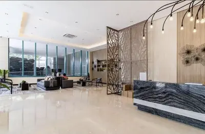 a living room with a large lobby with a couch at ONE UPTOWN RESIDENCES in Manila