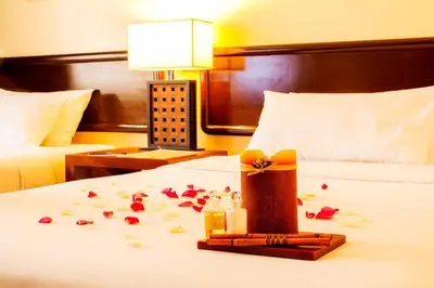 a hotel room with a bed with a gift on it at AIM Conference Center in Manila