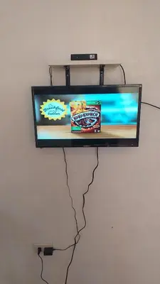 a tv hanging on a wall with at Mia and Miguel's House in General Trias