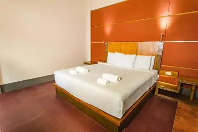 a bedroom with a large bed with two towels on it at The Park - Silang in Silang