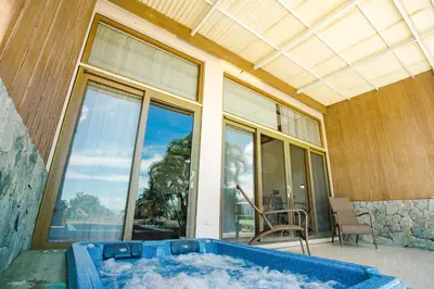 a hot tub in front of a house with a window at The Park - Silang in Silang