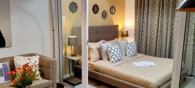a bedroom with a bed with a mirror at AZURE Urban Resort Residences 1BR Condo with huge wavepool & man-made beach near Airport in Manila