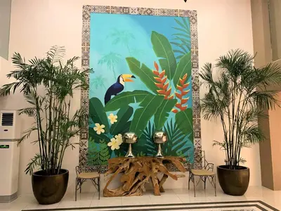 a wall mural with plants and a table and chairs at AZURE Urban Resort Residences 1BR Condo with huge wavepool & man-made beach near Airport in Manila