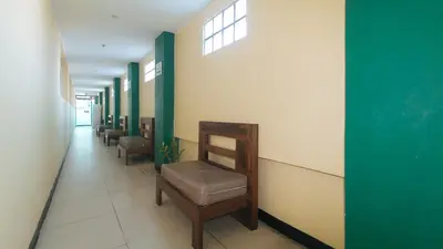 a hallway with a row of chairs in a waiting room at RedDoorz at Ranchotel Alabang in Manila