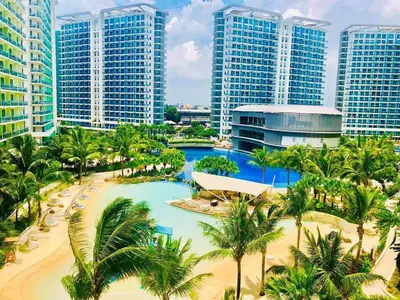 a view of a resort with palm trees and buildings at Azure C3 Balcony Wifi near mall airport in Manila